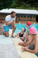 Swimming instructor assisting senior swimmers