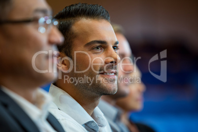 Business executives listening to speech