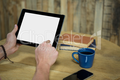 Man using digital tablet in coffee shop