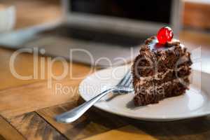 Pastry served in plate at coffee shop