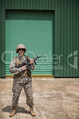 Military soldier standing with a rifle