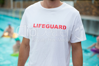 Mid section of lifeguard at poolside