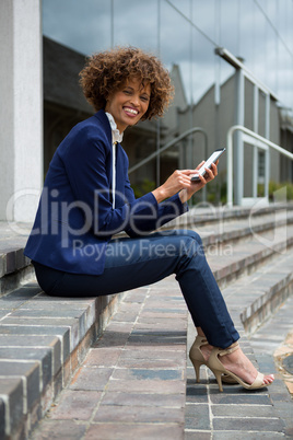Businesswoman using mobile phone in the premises