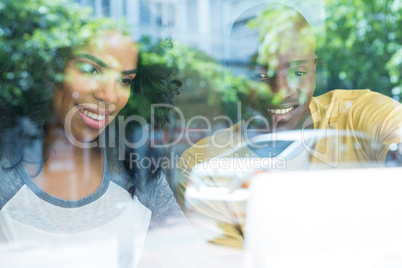 Multi ethnic young couple in coffee shop