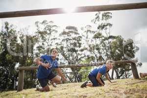 People passing through hurdles during obstacle course