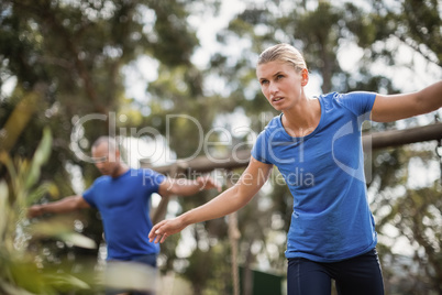 Fit man and woman during obstacle course training