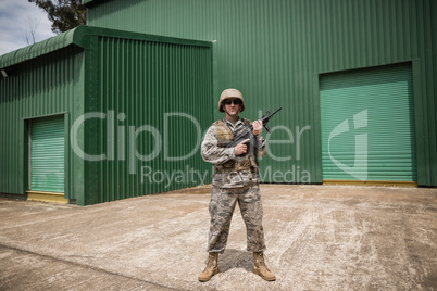 Military soldier standing with a rifle