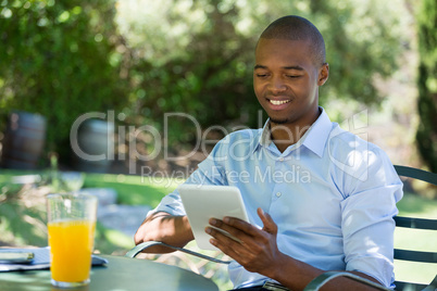 Businessman using digital tablet at restaurant