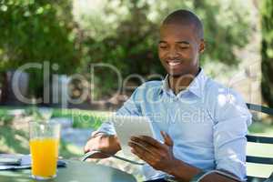 Businessman using digital tablet at restaurant