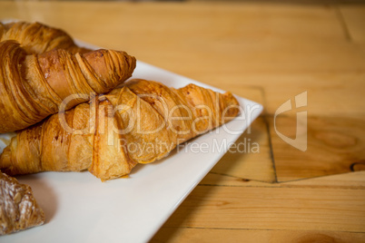 Croissant served in plate at coffee house