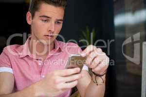 Man using mobile phone in coffee shop