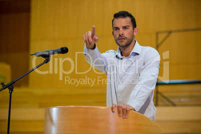 Business executive pointing while giving a speech