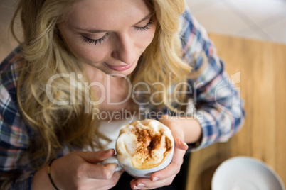 Young woman having coffee in cafe