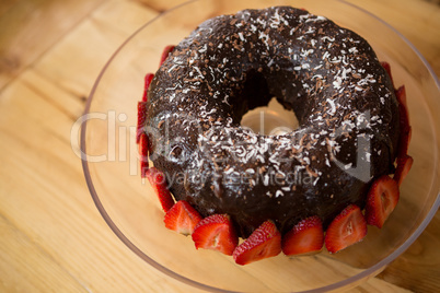 Bundt cake surrounded by strawberries in coffee shop