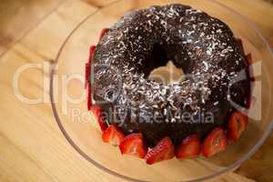 Bundt cake surrounded by strawberries in coffee shop