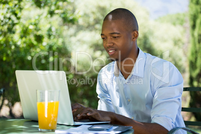 Businessman using laptop at restaurant