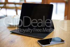 Close-up of digital tablet and smart phone on table