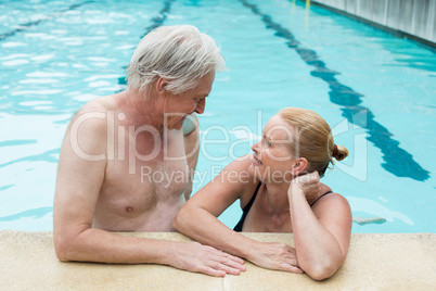 Couple looking at each other at poolside