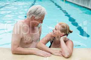 Couple looking at each other at poolside