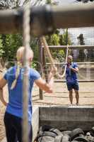 Fit man and woman practicing during obstacle course