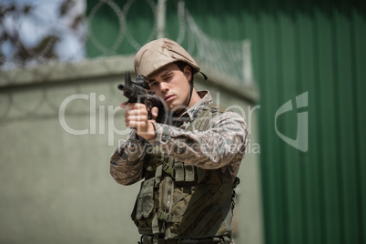 Military soldier aiming with a rifle