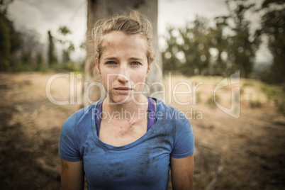 Portrait of determined woman standing during obstacle course