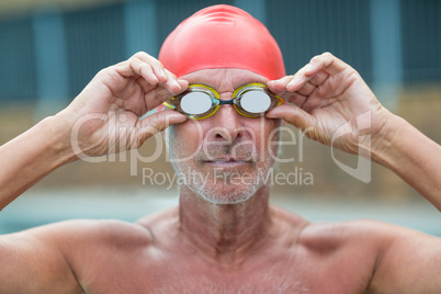 Shirtless male swimmer wearing swimming goggles