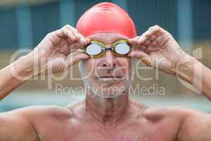 Shirtless male swimmer wearing swimming goggles