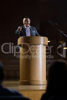 Business executive pointing while giving a speech