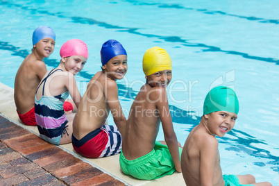 Happy of friends sitting at poolside