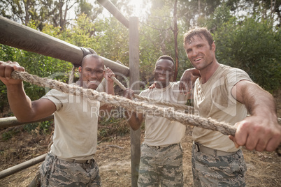 Portrait of military soldiers smiling during obstacle training