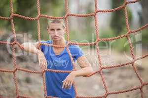 Fit woman standing near fitness trial at boot camp