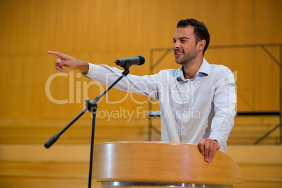 Business executive pointing while giving a speech