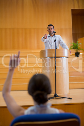 Business executive pointing towards audience