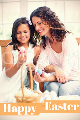 Composite image of happy mother and daughter holding easter eggs