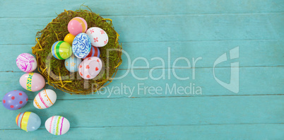 Painted Easter eggs against blue wood background