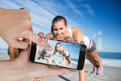 Composite image of hands touching smart phone