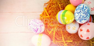 Painted Easter eggs against blue wood background