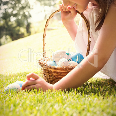 Little girl collecting easter eggs