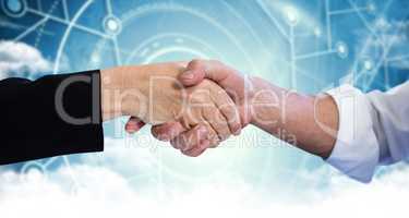 Composite image of business partners shaking hands