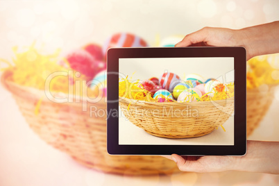 Composite image of close-up of hands holding digital tablet