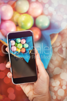 Composite image of hand holding mobile phone against white background