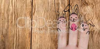 Composite image of vector image of fingers painted as easter bunny