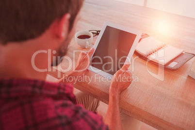 Man using tablet on wooden table