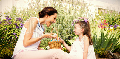 Mother and daughter collecting easter eggs