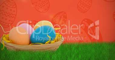 Composite image of colorful easter eggs in wicker basket