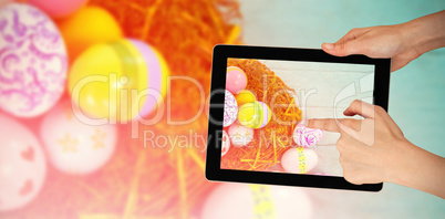 Composite image of hands touching digital tablet against white background