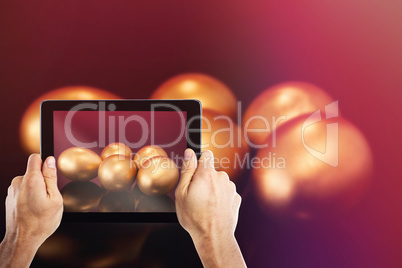 Composite image of cropped hand holding digital tablet