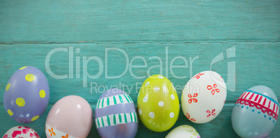 Painted Easter eggs on wooden surface