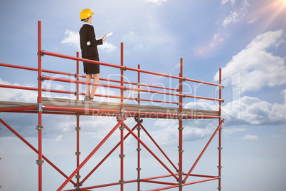 Composite image of smiling architect with hard hat